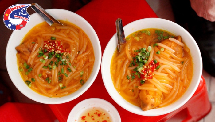Vietnamese thick noodle soup with characteristic orange color