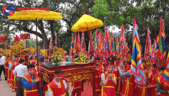 Ba La palanquin procession through the tree-lined road during the La Temple Festival