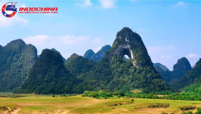 Scenic view of Cao Bang’s mountains with a large natural arch, perfect for motorcycle tours