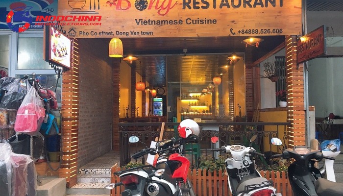 Entrance of Bong Restaurant in Dong Van with motorbikes parked outside