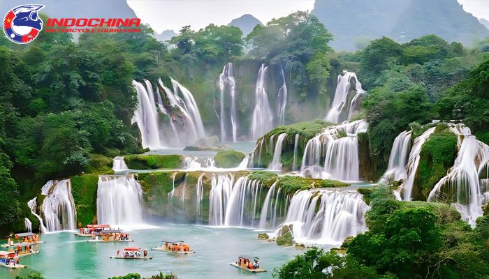 Stunning view of Ban Gioc Waterfalls surrounded by lush greenery and tourists on boats